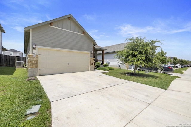 11631 Troubadour, San Antonio, TX 78245 - view of front of home featuring board and batten siding, concrete driveway, a garage, and stone siding