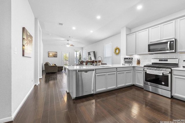11631 Troubadour, San Antonio, TX 78245 - kitchen featuring stainless steel appliances, a peninsula, light countertops, backsplash, and open floor plan