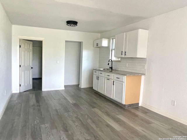3022 El Paso, San Antonio, TX 78207 - kitchen with dark wood finished floors, decorative backsplash, white cabinets, and light stone countertops