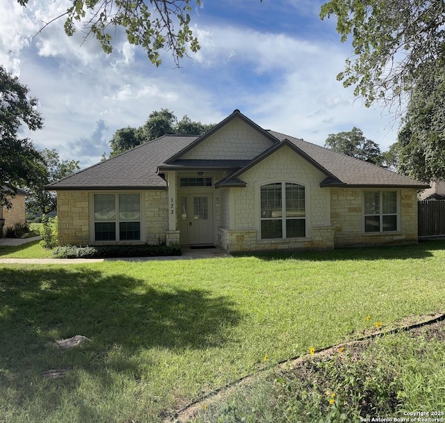 173 Great Oaks Ln, Vernia, TX 78121 - view of front of property with stone siding, a front lawn, and roof with shingles