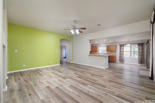 173 Great Oaks Ln, Vernia, TX 78121 - unfurnished living room featuring ceiling fan, light wood-type flooring, arched walkways, and recessed lighting