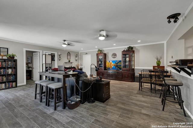 332 W Klein, Seguin, TX 78155 - living room with a ceiling fan, crown molding, dark wood-style flooring, and recessed lighting