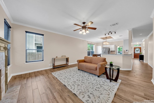 11546 Creek Bow, San Antonio, TX 78253 - living room featuring ceiling fan, ornamental molding, a tile fireplace, and light wood-style flooring
