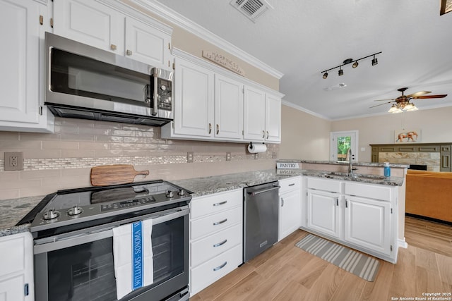 11546 Creek Bow, San Antonio, TX 78253 - kitchen featuring appliances with stainless steel finishes, ceiling fan, white cabinetry, light stone countertops, and a peninsula