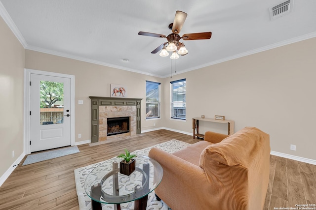 11546 Creek Bow, San Antonio, TX 78253 - living area with healthy amount of natural light, ceiling fan, light wood-style floors, crown molding, and a stone fireplace