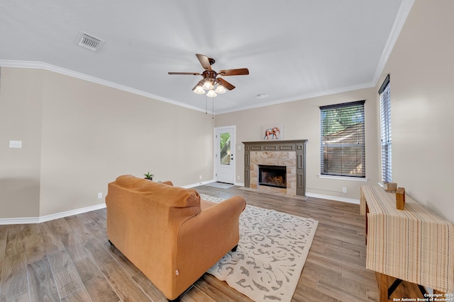 11546 Creek Bow, San Antonio, TX 78253 - living room with ceiling fan, plenty of natural light, a fireplace, light wood-type flooring, and crown molding