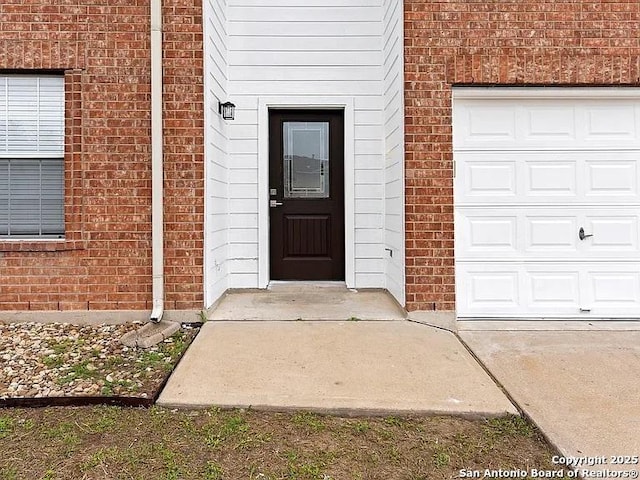 221 Peppergrass Cv, Kyle, TX 78640 - entrance to property with brick siding and a garage