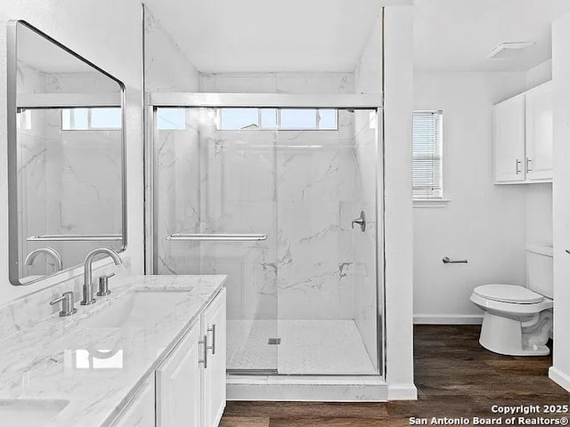 221 Peppergrass Cv, Kyle, TX 78640 - full bathroom featuring vanity, a marble finish shower, and wood finished floors