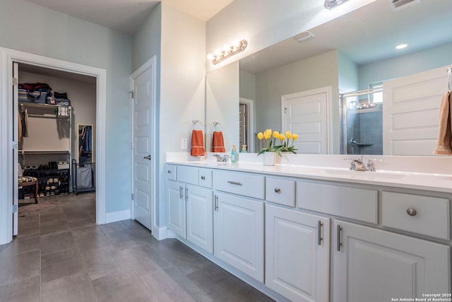 13822 Greater Straw, San Antonio, TX 78254 - bathroom featuring double vanity, a shower stall, and a spacious closet