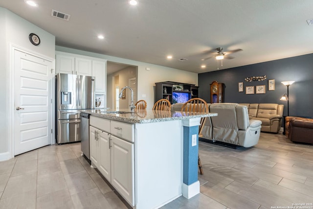 13822 Greater Straw, San Antonio, TX 78254 - kitchen featuring stainless steel appliances, open floor plan, light stone countertops, recessed lighting, and a ceiling fan