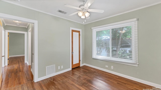 1261 Mill, New Braunfels, TX 78130 - unfurnished room with dark wood-style flooring, crown molding, and ceiling fan