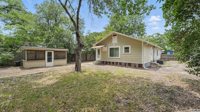 1261 Mill, New Braunfels, TX 78130 - back of house with a sunroom, a fenced backyard, and entry steps
