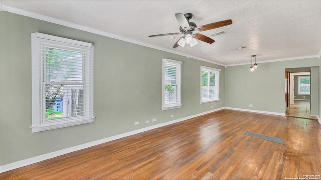 1261 Mill, New Braunfels, TX 78130 - unfurnished room with wood-type flooring, a textured ceiling, ceiling fan, and crown molding