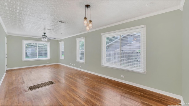 1261 Mill, New Braunfels, TX 78130 - empty room featuring wood finished floors, healthy amount of natural light, ornamental molding, and a ceiling fan