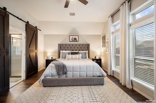 2129 Rustling Way, Seguin, TX 78155 - bedroom featuring a barn door, dark wood-style floors, and a ceiling fan