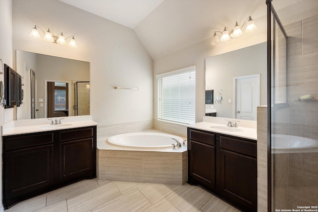 2129 Rustling Way, Seguin, TX 78155 - full bathroom featuring a stall shower, two vanities, a garden tub, vaulted ceiling, and tile patterned flooring