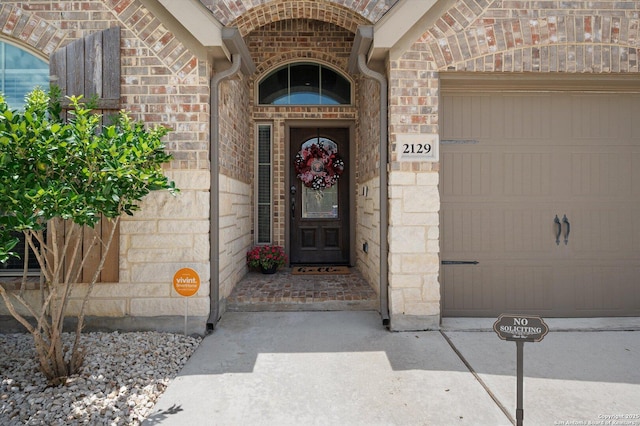 2129 Rustling Way, Seguin, TX 78155 - property entrance with an attached garage, stone siding, and brick siding