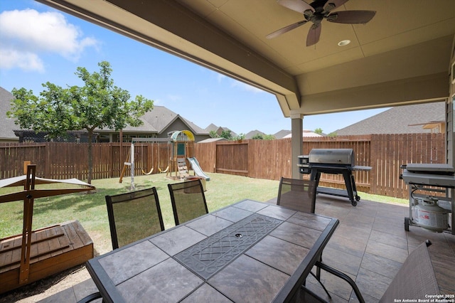 2129 Rustling Way, Seguin, TX 78155 - fenced backyard with outdoor dining area, ceiling fan, a patio, a grill, and a playground