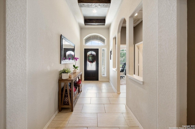 2129 Rustling Way, Seguin, TX 78155 - entrance foyer with a textured wall, a towering ceiling, arched walkways, and light tile patterned floors
