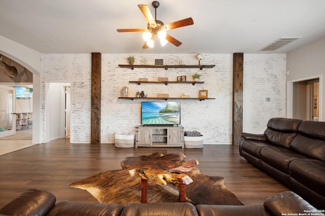 2129 Rustling Way, Seguin, TX 78155 - living room with a ceiling fan, arched walkways, and wood finished floors