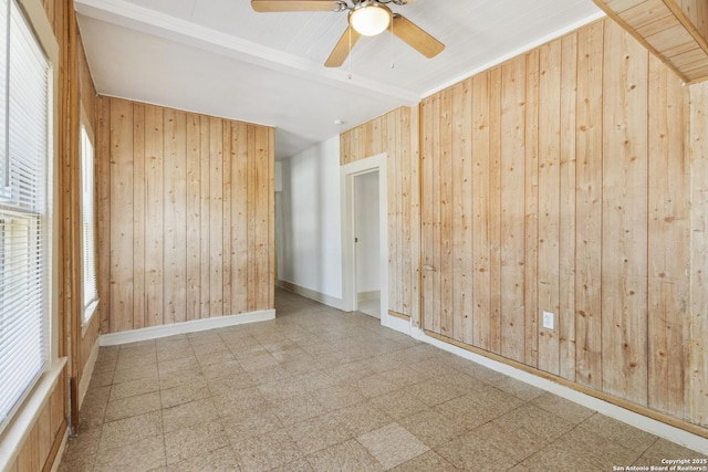 2121 San Fernando, San Antonio, TX 78207 - spare room featuring wood walls, a ceiling fan, and tile patterned floors