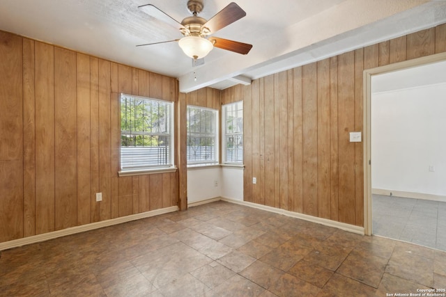 2121 San Fernando, San Antonio, TX 78207 - unfurnished room with wood walls, beamed ceiling, and ceiling fan