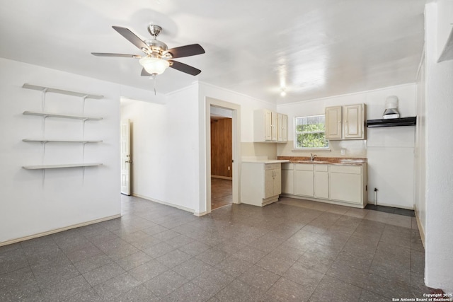 2121 San Fernando, San Antonio, TX 78207 - kitchen featuring ceiling fan, light countertops, and granite floors