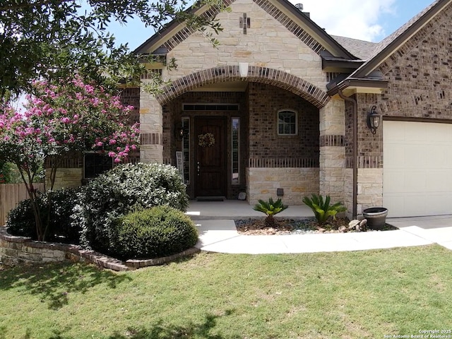 3822 Cordoba Crk, San Antonio, TX 78259 - doorway to property featuring stone siding, a yard, an attached garage, and brick siding