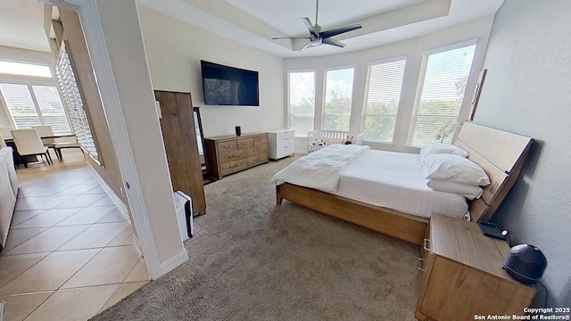 3822 Cordoba Crk, San Antonio, TX 78259 - bedroom featuring a raised ceiling, light tile patterned flooring, and ceiling fan