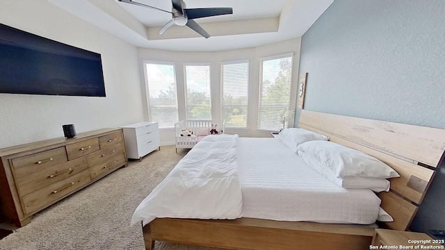 3822 Cordoba Crk, San Antonio, TX 78259 - bedroom with light carpet, a raised ceiling, and a ceiling fan