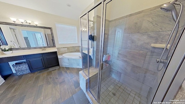 3822 Cordoba Crk, San Antonio, TX 78259 - bathroom featuring vanity, a garden tub, a stall shower, and wood finished floors
