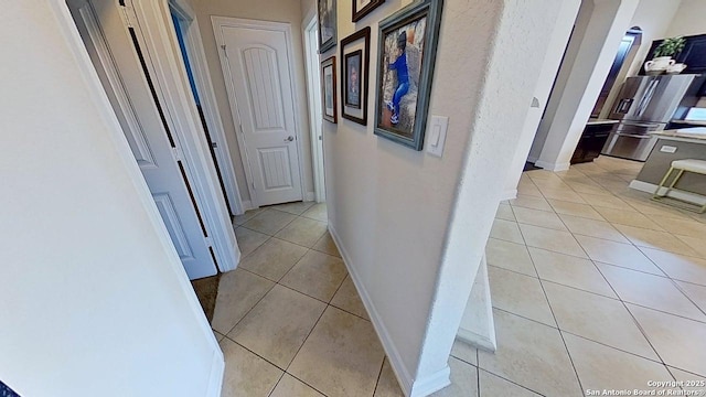 3822 Cordoba Crk, San Antonio, TX 78259 - hallway featuring light tile patterned floors and baseboards