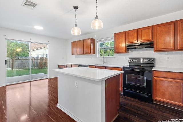7622 Braes Stage, San Antonio, TX 78254 - kitchen featuring black electric range oven, under cabinet range hood, light countertops, and dark wood-style flooring