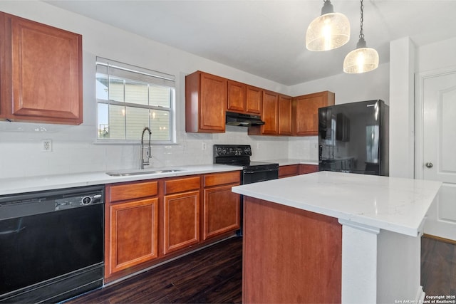 7622 Braes Stage, San Antonio, TX 78254 - kitchen with black appliances, under cabinet range hood, dark wood-type flooring, tasteful backsplash, and brown cabinetry
