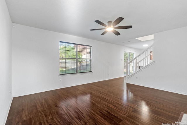 7622 Braes Stage, San Antonio, TX 78254 - empty room featuring a ceiling fan, stairs, healthy amount of natural light, and wood finished floors