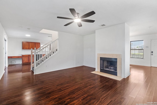 7622 Braes Stage, San Antonio, TX 78254 - unfurnished living room featuring dark wood-type flooring, stairs, ceiling fan, and a fireplace