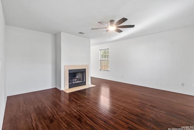 7622 Braes Stage, San Antonio, TX 78254 - unfurnished living room featuring a ceiling fan, a fireplace with flush hearth, and dark wood-style flooring