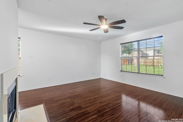 7622 Braes Stage, San Antonio, TX 78254 - unfurnished living room with a ceiling fan, dark wood-style flooring, and a fireplace with flush hearth