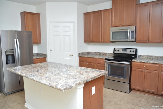7431 Magnolia Blf, San Antonio, TX 78218 - kitchen with stainless steel appliances, light tile patterned floors, brown cabinets, light stone countertops, and a kitchen island