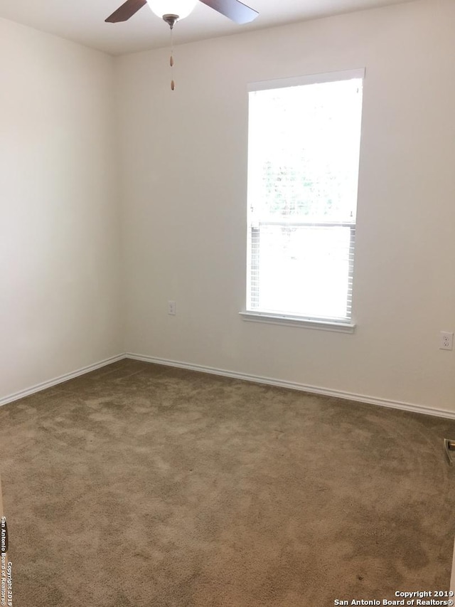 7431 Magnolia Blf, San Antonio, TX 78218 - carpeted empty room with a ceiling fan and healthy amount of natural light