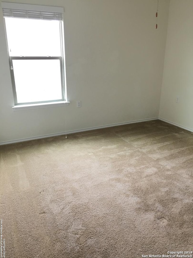 7431 Magnolia Blf, San Antonio, TX 78218 - empty room with carpet flooring and healthy amount of natural light