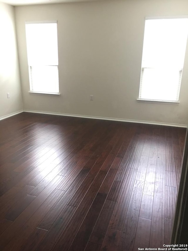 7431 Magnolia Blf, San Antonio, TX 78218 - unfurnished room featuring dark wood-style floors and baseboards
