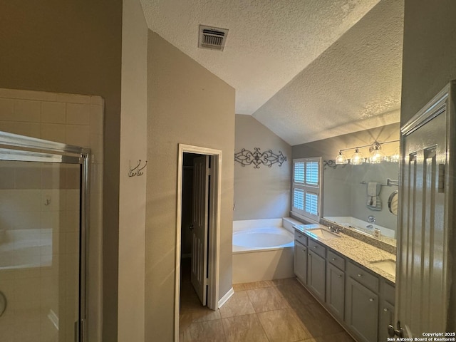 13711 Auburn Oaks, San Antonio, TX 78247 - bathroom featuring a textured ceiling, a garden tub, lofted ceiling, a shower stall, and double vanity