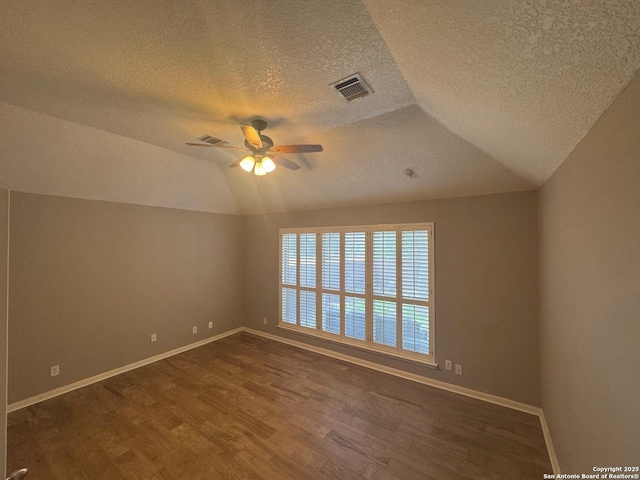 13711 Auburn Oaks, San Antonio, TX 78247 - unfurnished room with a textured ceiling, dark wood-style floors, vaulted ceiling, and a ceiling fan