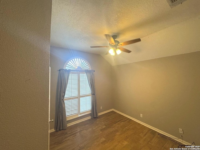 13711 Auburn Oaks, San Antonio, TX 78247 - empty room featuring a textured ceiling, a ceiling fan, dark wood-style flooring, and vaulted ceiling