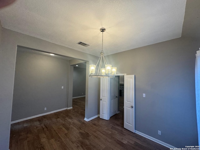 13711 Auburn Oaks, San Antonio, TX 78247 - unfurnished dining area with a chandelier, wood finished floors, and a textured ceiling