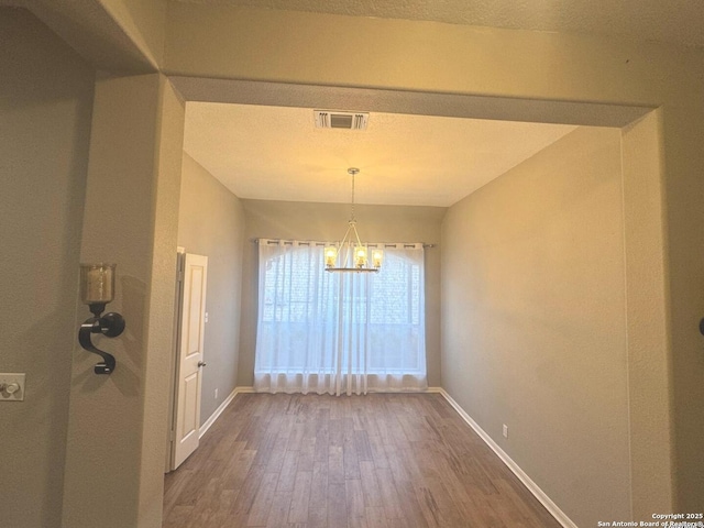 13711 Auburn Oaks, San Antonio, TX 78247 - unfurnished dining area featuring a chandelier and wood finished floors