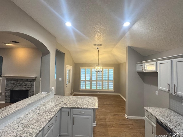 13711 Auburn Oaks, San Antonio, TX 78247 - kitchen with arched walkways, dark wood-style flooring, a textured ceiling, open floor plan, and a chandelier