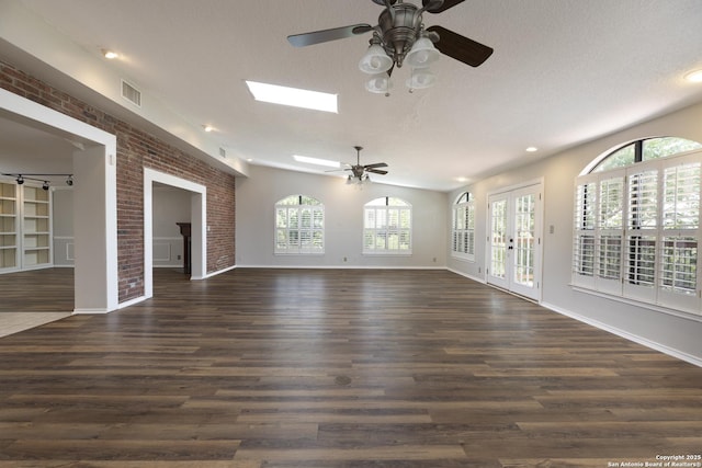 18510 Paloma Wood, San Antonio, TX 78259 - unfurnished living room with ceiling fan, dark wood-style floors, healthy amount of natural light, a textured ceiling, and french doors
