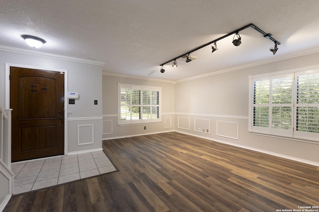 18510 Paloma Wood, San Antonio, TX 78259 - foyer entrance with wood finished floors, track lighting, a textured ceiling, wainscoting, and ornamental molding
